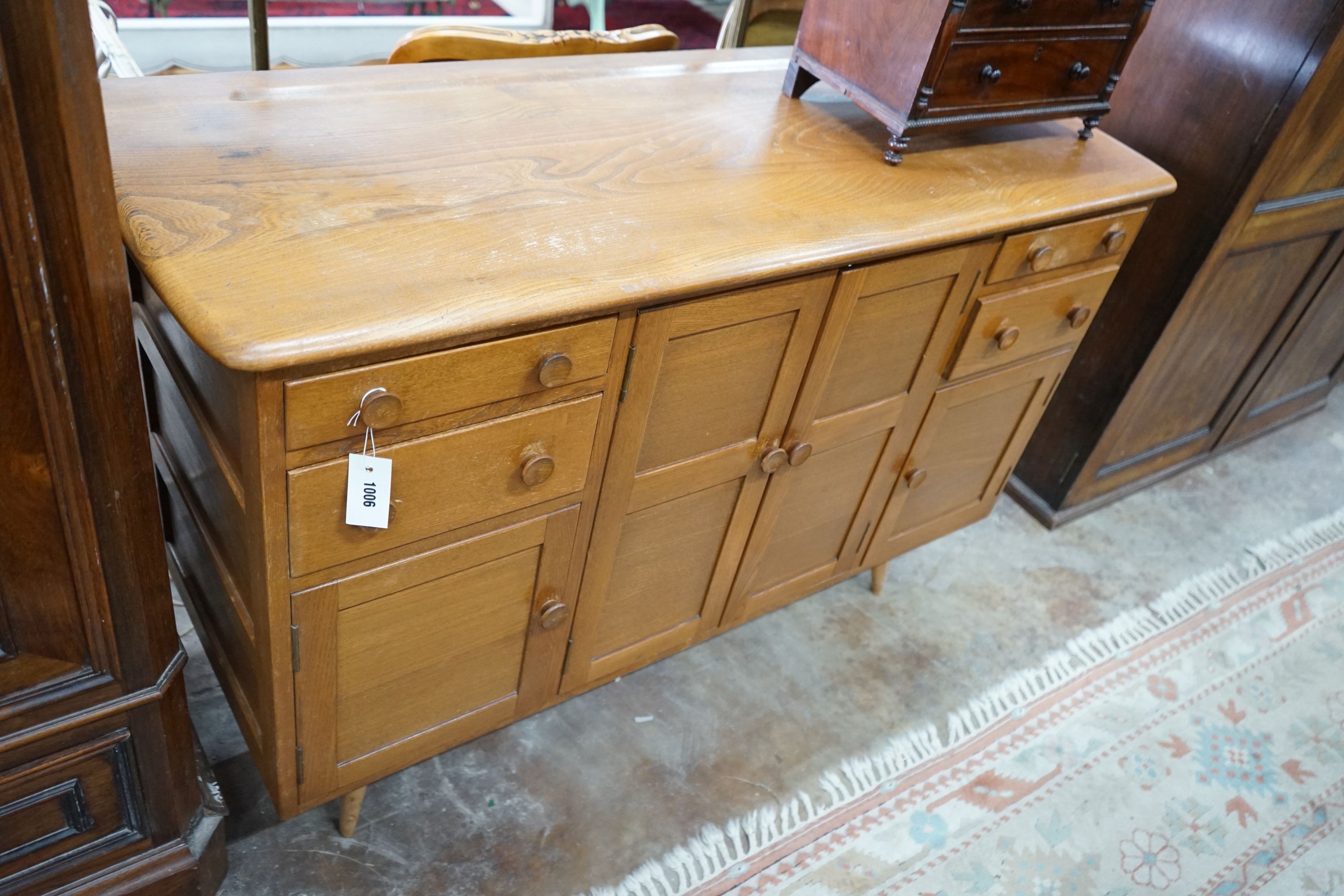 An Ercol elm sideboard, length 130cm, depth 49cm, height 86cm